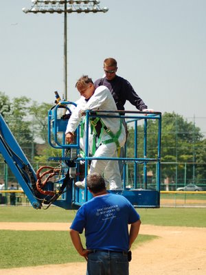 Workers employed by the New York City Department of Design and Construction working to safely recover wild baby Quaker Parrots at the Throggs Neck Little League baseball field, June 7, 2007